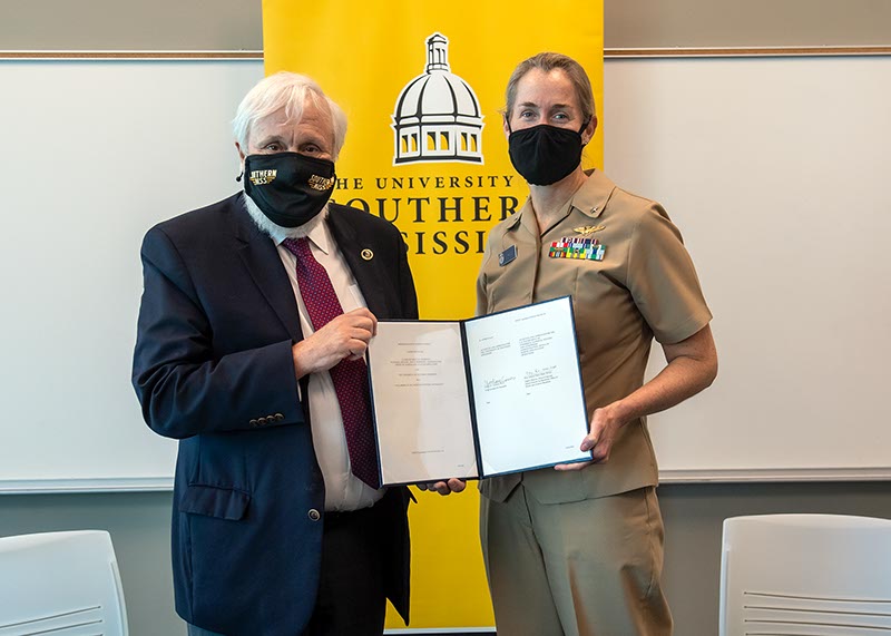 Dr. Gordon Cannon and Rear Adm. Nancy Hann pose with the agreement