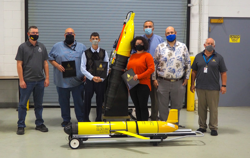 Instructors and students with some of the uncrewed maritime equipment