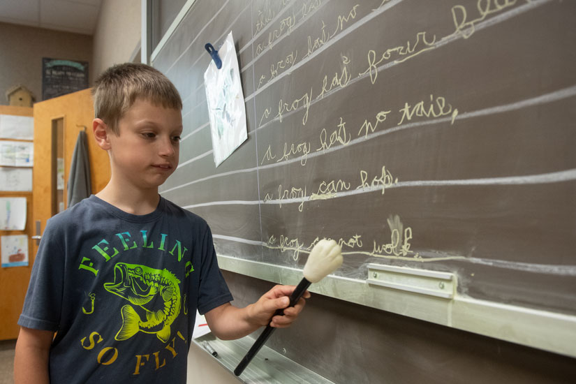 Austin Shavers works on a classroom assignment at the DuBard School. (Photo by Kelly Dunn)