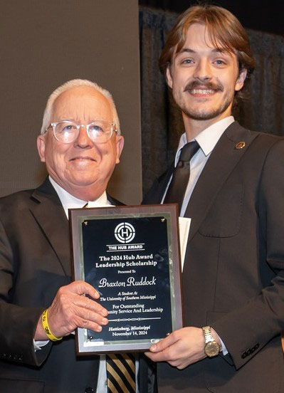 Southern Miss President Dr. Joseph S. Paul, left, presents Braxton Ruddock, senior and president of the Student Government Association, with the 2024 Hub Award Leadership Scholarship (photo courtesy of the Pinebelt Foundation).